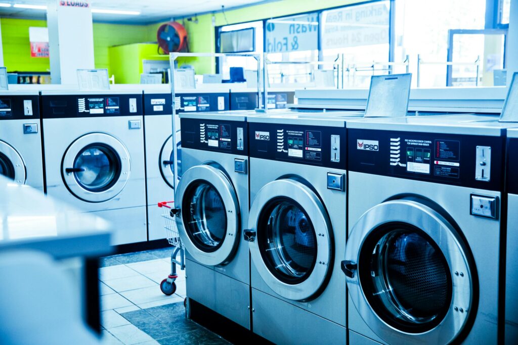 pexels photo 4700420 4700420 Contemporary laundromat showcasing a row of industrial washing machines for public use.